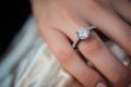 Close up of an elegant diamond ring on young woman finger