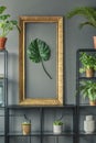 Close-up of an elegant, golden frame with a green monstera leaf Royalty Free Stock Photo