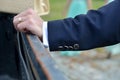 Close up of elegant groom hand with ring. He keeps the hand on t