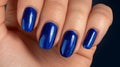 Close up of elegant woman s hand displaying stunning blue nail polish in stylish fashion