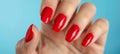 Close up of elegant woman s hand with stylish red nail polish on perfectly manicured fingernails