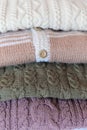 Close up on 4 elegant wool sweaters or jumpers in the column Royalty Free Stock Photo