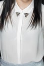 Close-up, an element of clothing, a decorative collar of a white blouse for a girl with dark hair, fashion and style