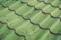 Close up of element of green tiled roof surface of residential cottage house