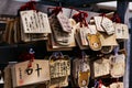 Close up Ema are small wooden plaques, common to Japan, in which Shinto and Buddhist worshippers write prayers or wishes. Royalty Free Stock Photo