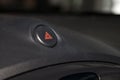 Close-up on emergency button with red icon on the car dashboard. Problem, crash and damage concept