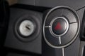 Close-up on emergency round button with red triangle icon on the car plastic dashboard. Problem, crash and damage concept Royalty Free Stock Photo