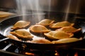 Close-up of empanadas being fried in a pan, showing off their crispy and golden exterior with steam rising from the hot oil