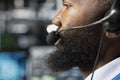 Close up of employee in server farm talking in mic, coordinating technicians Royalty Free Stock Photo