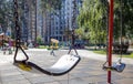 Close up empty baby swing in the park. New chain swing. Set of black swing chains on a modern playground. Focus on the swing in Royalty Free Stock Photo