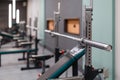 Close up of empty barbell bar without plates on rack in gym club. Royalty Free Stock Photo