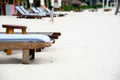 Close-up empty beach lounge chairs and collapsed umbrella on white sandy beach in early morning at luxury resort, Nha Trang, Royalty Free Stock Photo