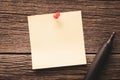 Close up of empty blank note paper pinned to a wooden background and black marker Royalty Free Stock Photo