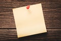 Close up of empty blank paper note pinned to a wooden background Royalty Free Stock Photo