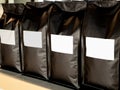 Close Up empty blank white label on modern black bag coffee beans packaging. Royalty Free Stock Photo