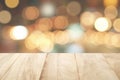 empty rustic wooden table top with blurred warm tone color lights bokeh background Royalty Free Stock Photo