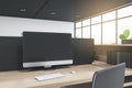 Close up of empty computer monitor in coworking office interior with wooden desk and bright city view. 3D Rendering