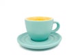 Close-up of empty cyan cup with cyan plate. Yellow colour inside of the coup. Royalty Free Stock Photo