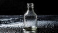 Close up of empty glass bottle on wet surface with dark background