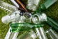 close up of empty glass bottles and jars on grass Royalty Free Stock Photo