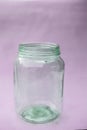 Close up of empty glass jar or storage jar or glass container isolated on pink surface Royalty Free Stock Photo