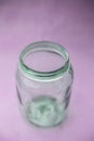 Close up of empty glass jar or storage jar or glass container isolated on pink surface Royalty Free Stock Photo