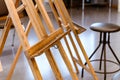 Close up of empty old stained wooden easel tripod for painting frame and canvas in the studio Royalty Free Stock Photo