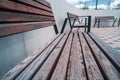 Close-up of an empty painted wooden bench in a modern city park at sunset Royalty Free Stock Photo