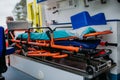 Close-up of empty stretcher inside ambulance vehicle.