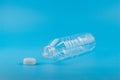 Close up of an empty used plastic bottle on blue background,Recyclable waste Royalty Free Stock Photo