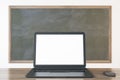 Close up of empty white laptop and mouse on chalkboard background, Education, seminar, workshop and mockup concept. Royalty Free Stock Photo