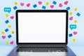 Close up of empty white mock up laptop screen with colorful social media icons on light background. Communication, follow and