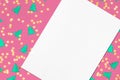 Close up of empty white rectangle poster mockup lying diagonally on pink christmas background