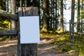 Close up of empty white sign on a wooden fence post in the woods Royalty Free Stock Photo