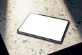 Close up of empty tablet on spotted table. Mock up, 3D Rendering Royalty Free Stock Photo