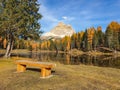 CLOSE UP: Empty wooden bench faces the breathtaking Lago d\'Antorno and Dolomites