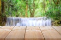 Wooden plank table top on vintage style with outdoor theme on blurred waterfall backgro
