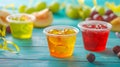 A close-up of an empty wooden table with colorful jello cups in the summer. Royalty Free Stock Photo