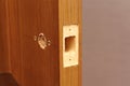 Close-up end hole for door latch inserting. Markup for doorknob installing