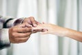 Groom hand holding bride hand and wear a wedding ring on bride ring finger