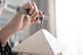 Close up engineer hand using Vernier caliper to measuring architectural model. work at home concept