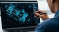 Engineer using stylus on laptop with 3D engineering blueprint on screen Royalty Free Stock Photo