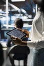 Close up of engineer using tablet in data center, updating neural networks Royalty Free Stock Photo