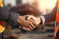 Close up of engineer and worker shaking hands on construction site background - Ai Generated