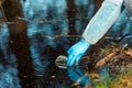 close-up environmentalist hand of a researcher, produces a process of taking a sample of water