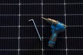 Close-up of Equipment of instruments for mounting and connecting solar photovoltaic system. Objects laying on solar panel. Concept Royalty Free Stock Photo