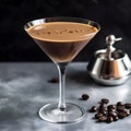 Close up of an Espresso Martini Cocktail based on coffee, liqueur and vodka isolated on a grey background. Served in an elegant