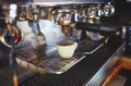 Close-up of espresso pouring from coffee machine.Espresso cup from coffee machine make by barista in shop cafe Royalty Free Stock Photo