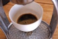 Close-up of espresso pouring from coffee machine. Man hand with coffee Royalty Free Stock Photo