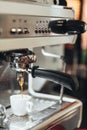 Close-up of espresso pouring from coffee machine. Professional coffee brewing. Royalty Free Stock Photo